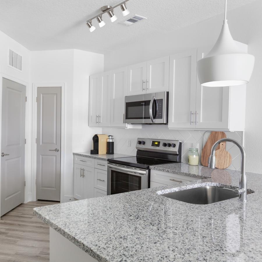 a kitchen with white cabinets