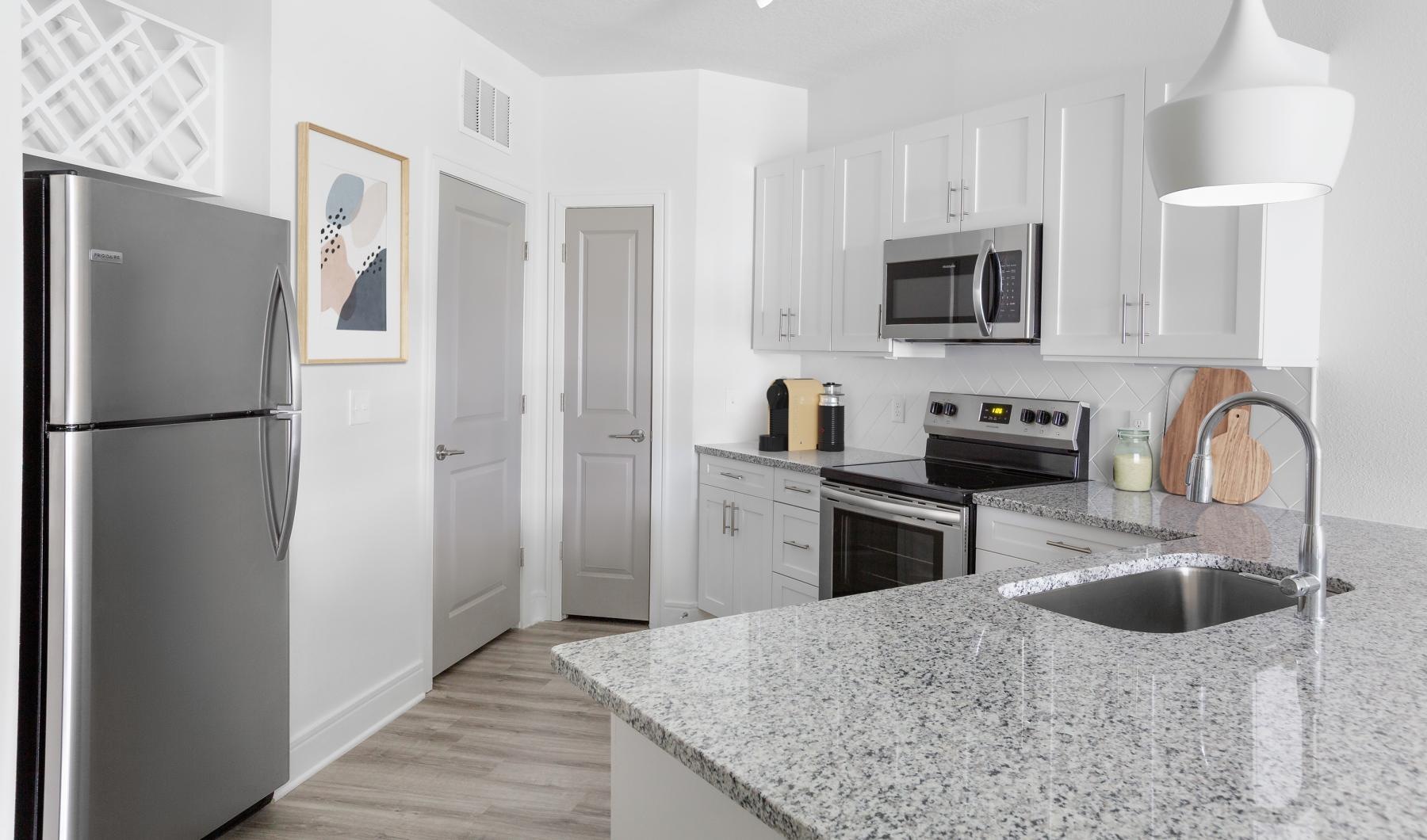 a kitchen with white cabinets