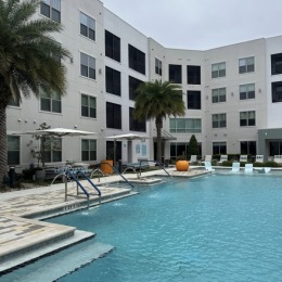 pool area showing reclining seating, wooden coverings and ample space