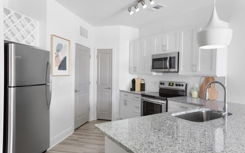 a kitchen with white cabinets