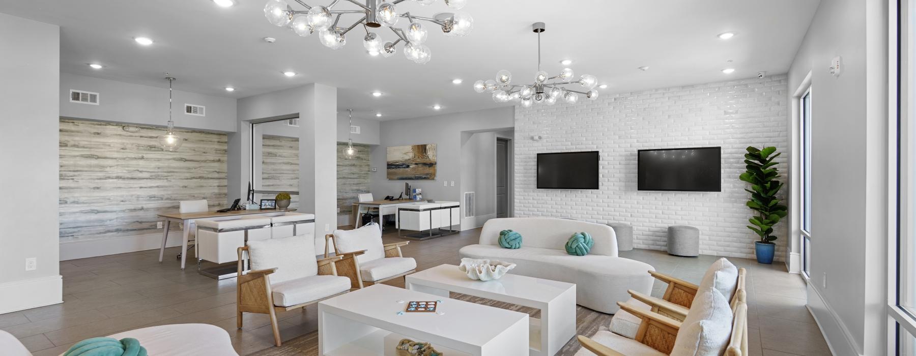 a large living room with a large white couch and a large chandelier